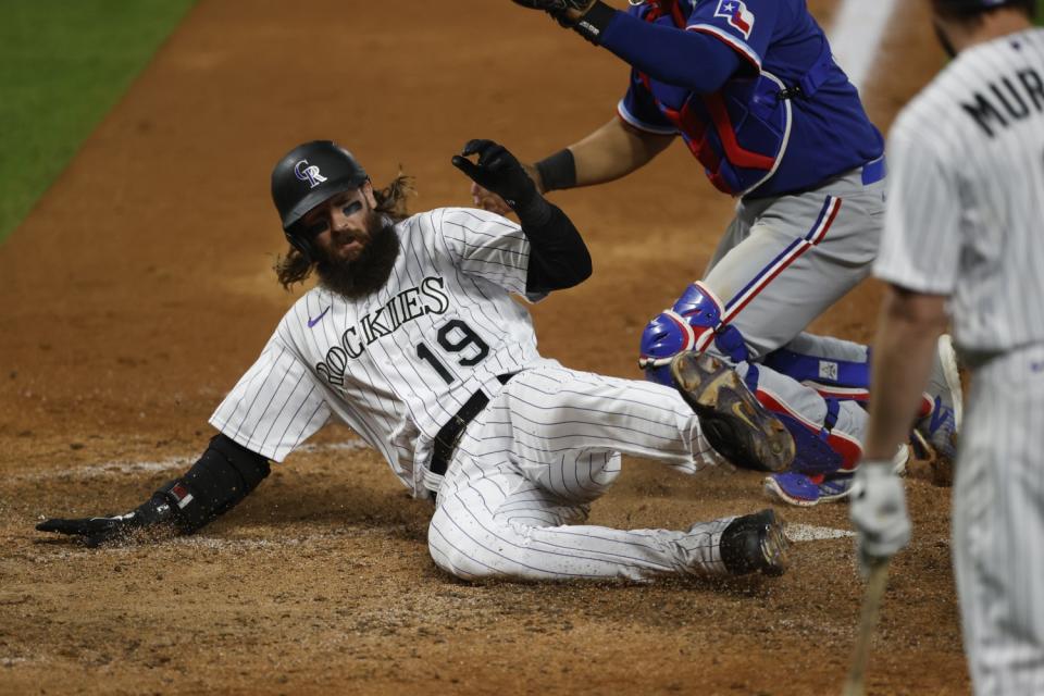 Colorado Rockies right fielder Charlie Blackmon slides into home against the Texas Rangers on Aug. 15.