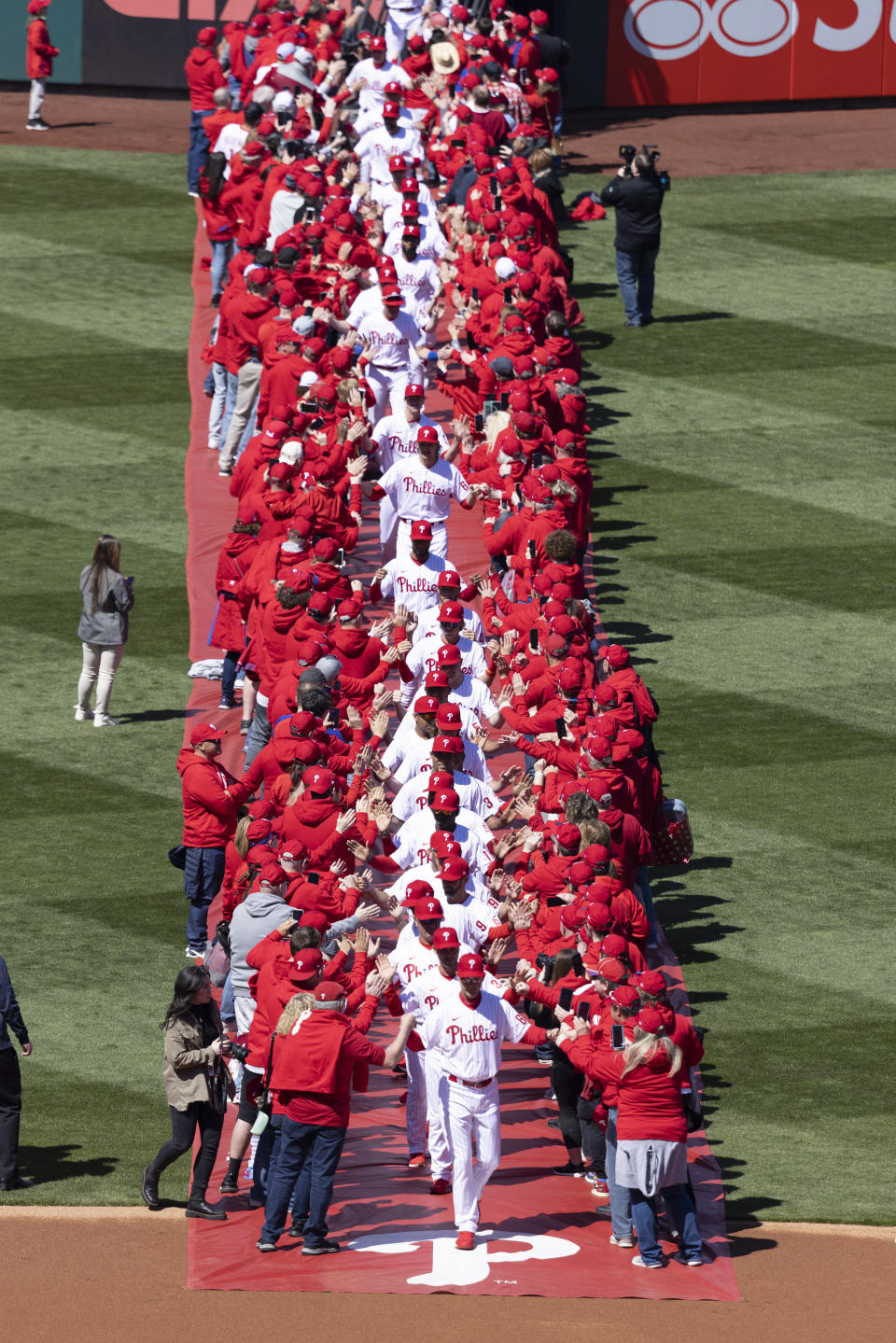 The Philadelphia Phillies take the field before a home opener baseball game against the Oakland Athletics, Friday, April 8, 2022, in Philadelphia. (AP Photo/Laurence Kesterson)