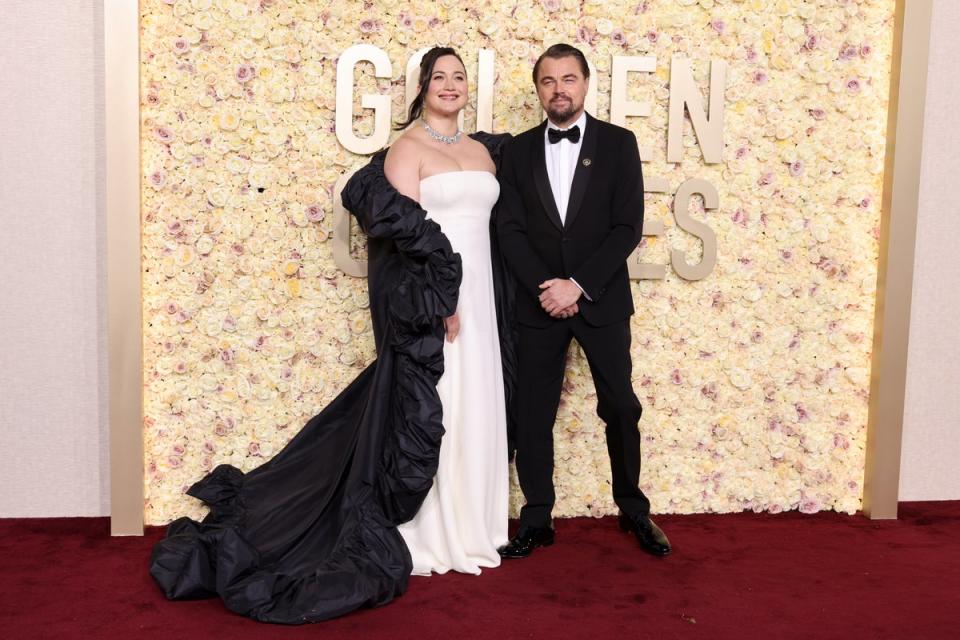 Leonardo DiCaprio wearing Giorgio Armani, and Lily Gladstone wearing Valentino (Getty Images)