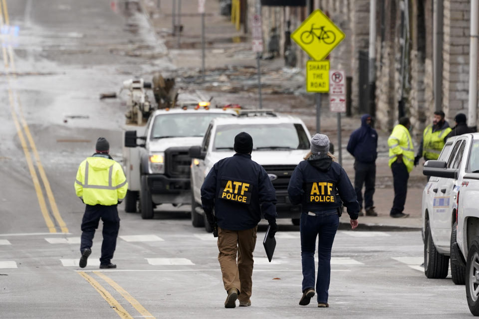 Emergency personnel work near the scene of an explosion in downtown Nashville, Tenn., Friday, Dec. 25, 2020. Buildings shook in the immediate area and beyond after a loud boom was heard early Christmas morning.(AP Photo/Mark Humphrey)