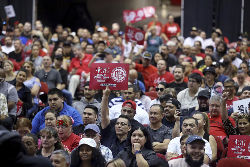 Culinary Union members, including German Hernandez, front center, who works at Luxor, holds up a sign as Culinary Union members rally ahead of a strike vote, Tuesday, Sept. 26, 2023, at Thomas & Mack Center on the UNLV campus in Las Vegas. Tens of thousands of hospitality workers who keep the iconic casinos and hotels of Las Vegas humming were set to vote Tuesday on whether to authorize a strike amid ongoing contract negotiations. (K.M. Cannon/Las Vegas Review-Journal via AP)