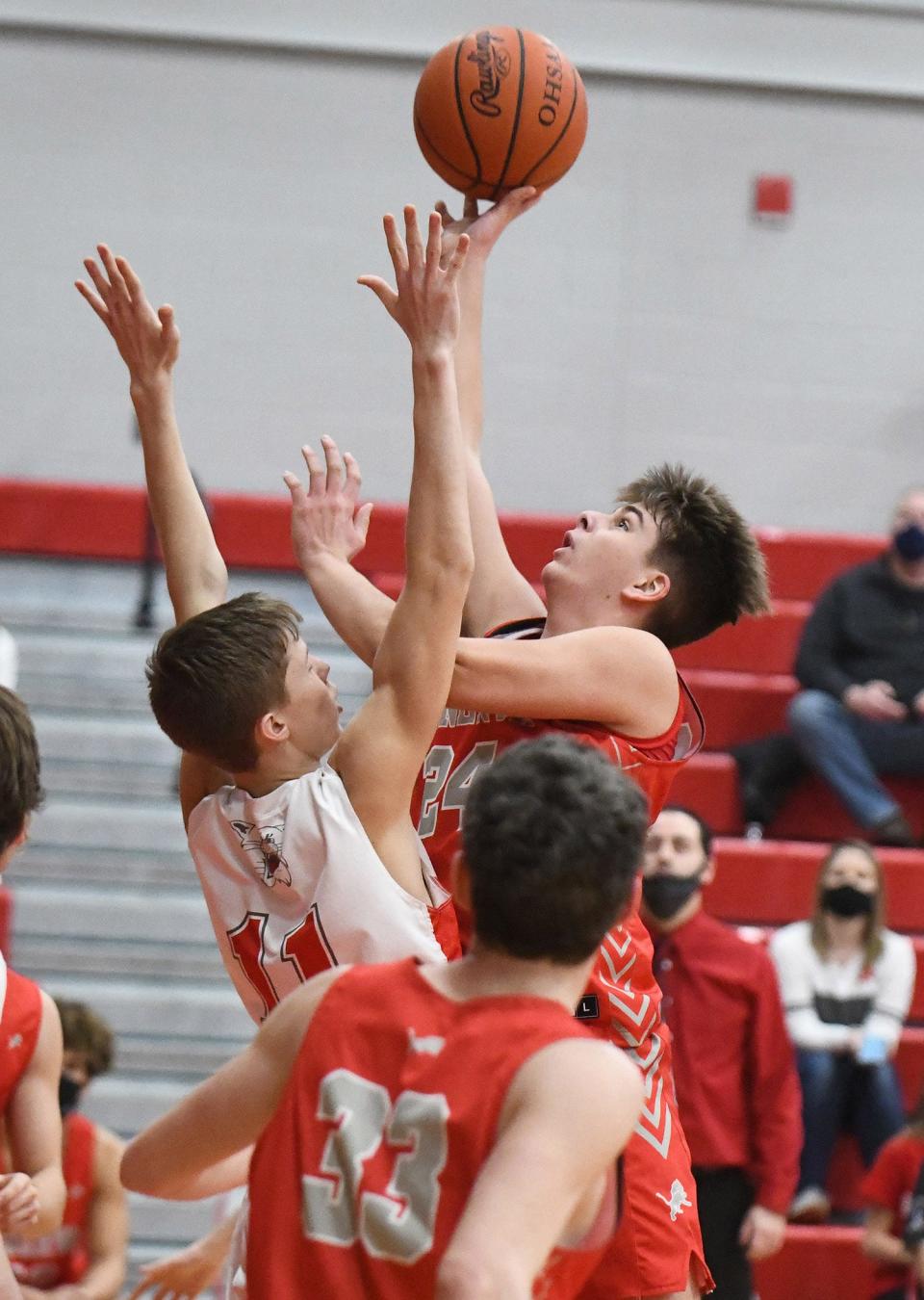 Brandon Costea of Minerva shoots over Gavin Burchfield of Canton South Saturday, February 20, 2021. 