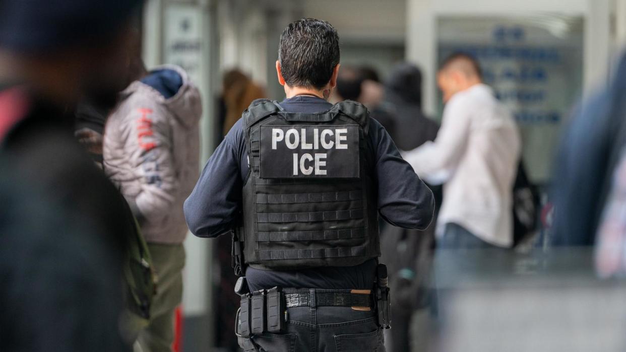 PHOTO: An ICE agent monitors asylum seekers being processed upon entering the Jacob K. Javits Federal Building, June 6, 2023, in New York City.  (David Dee Delgado/Getty Images)