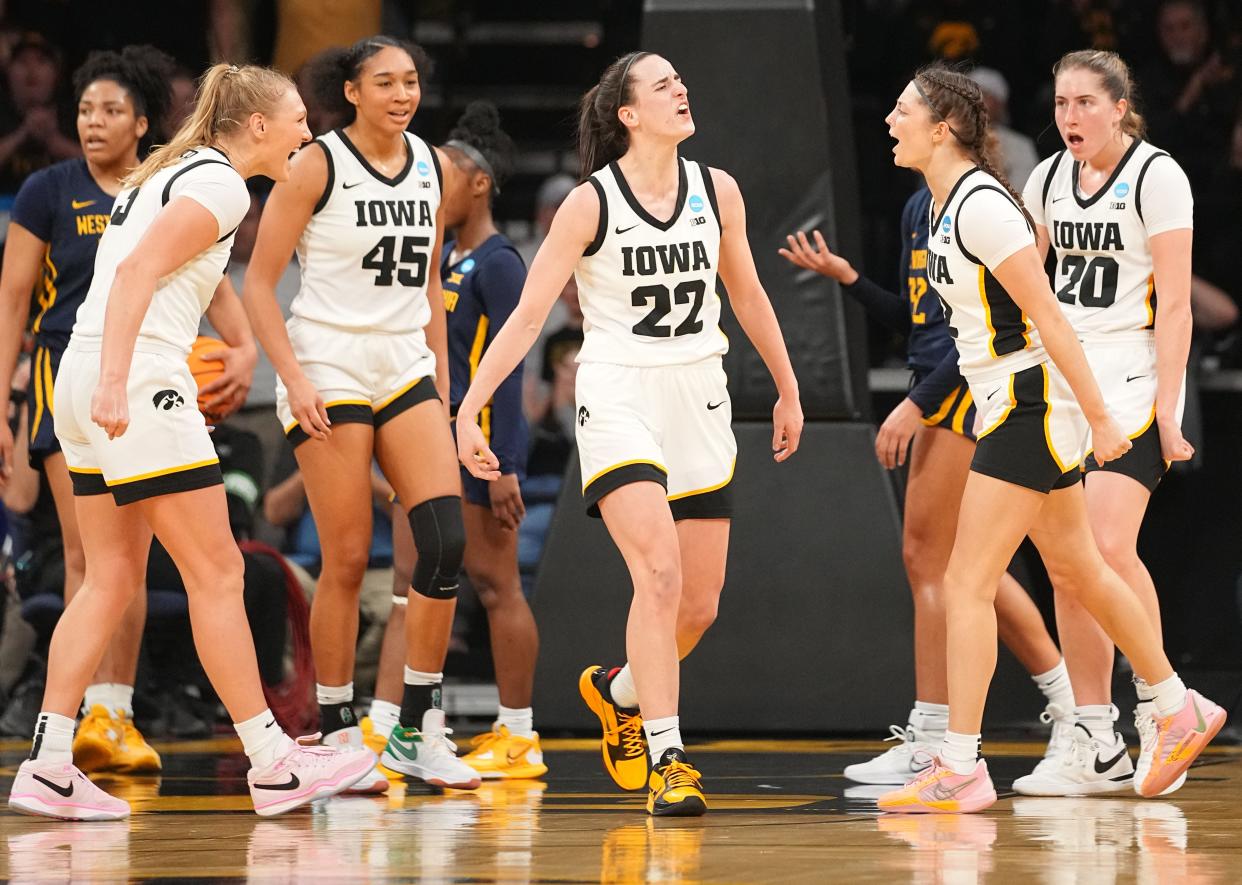 Iowa Hawkeyes guard Caitlin Clark (22) reacts after a basket in a second-round NCAA Tournament game between Iowa and West Virginia on Monday.