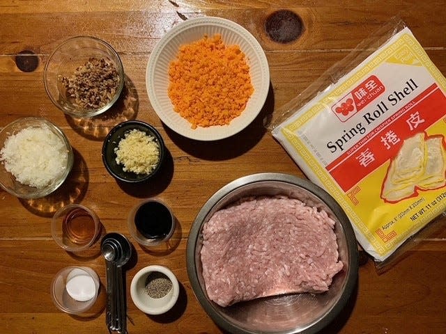 Beverly Lacsina, chef/owner of Walnut Street Kitchen in Montclair, and her mom prepare Filipino spring rolls