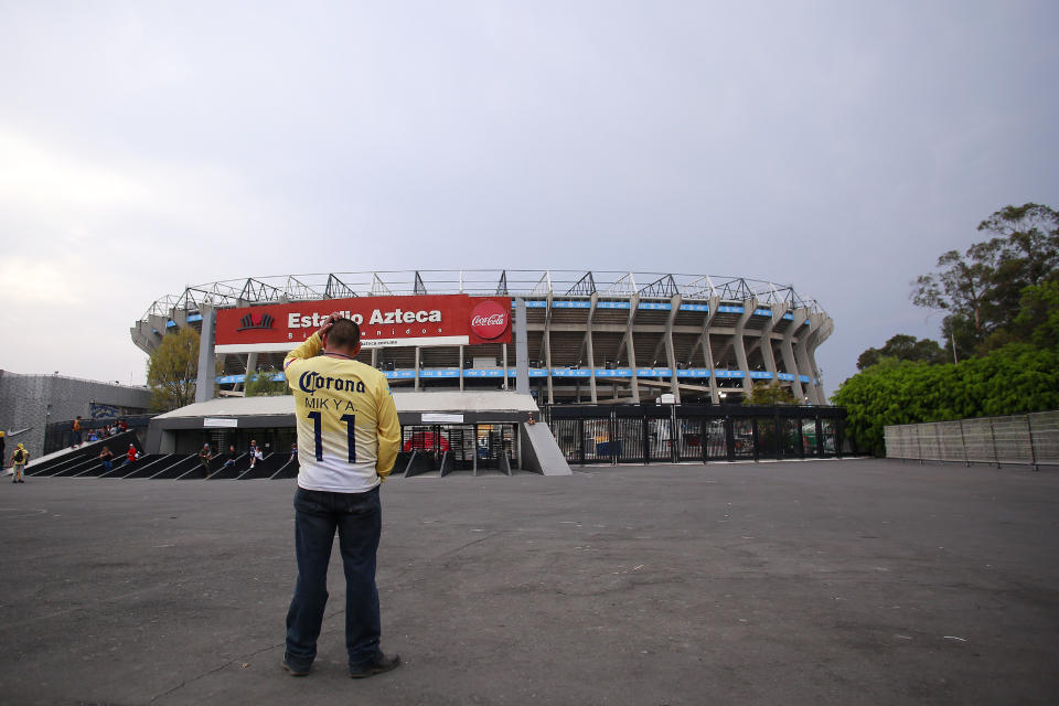 MEXICO CITY, MEXICO - MARCH 15: A fan of America looks the closed stadium prior to the 10th round match between America and Cruz Azul as part of the Torneo Clausura 2020 Liga MX at Azteca Stadium on March 15, 2020 in Mexico City, Mexico. The match is played behind closed doors to prevent the spread of the novel Coronavirus (COVID-19). (Photo by Mauricio Salas/Jam Media/Getty Images)