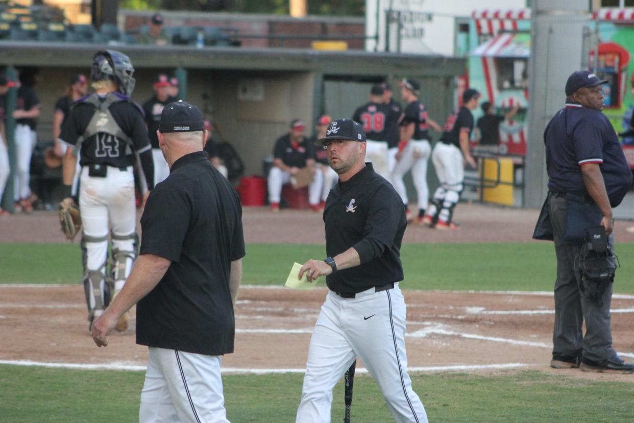 Calvary Day baseball coach Phillip Lee makes his way back to the dugout at Grayson Stadium in a playoff win over Morgan County on April 29, 2024.