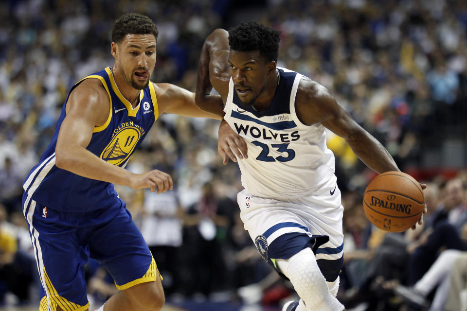 The Timberwolves’ Jimmy Butler, right, drives past the Warriors’ Klay Thompson during a preseason game. (AP)