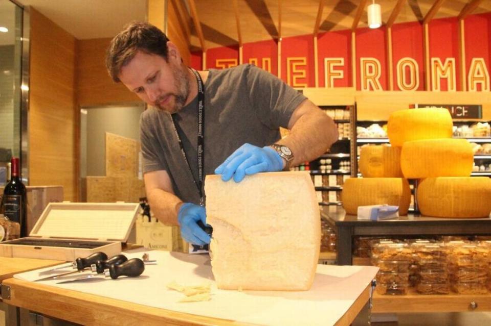 A staff member shaves a bit of Parmesan-Reggiano cheese in 2018 at the Whole Foods Market at 5298 University Parkway. James A. Jones Jr./jajones1@bradenton.com