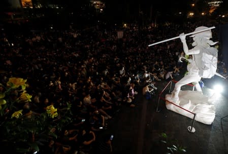 Protesters sit around Lady Liberty statue in Hong Kong