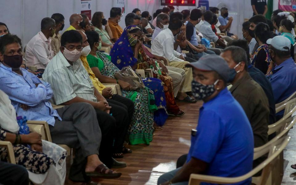 Residents in India wait to receive the vaccine for Covid-19 at a vaccination center in Mumbai - AP
