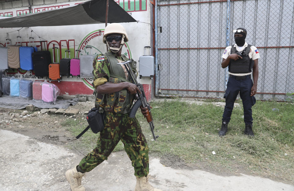 Kenyan and Haitian police patrol an area near the international airport in Port-au-Prince, Haiti, Wednesday, July 3, 2024. (AP Photo/Odelyn Joseph)