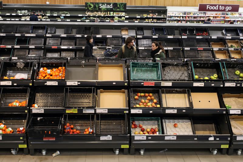 People are seen at the fruit and vegetable aisle in Sainsbury's supermarket