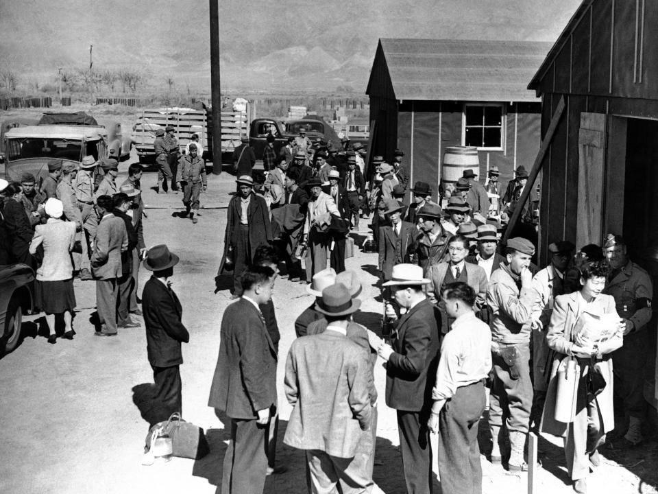 FILE - This March 23, 1942 photo shows the first arrivals at the Japanese evacuee community established in Owens Valley in Manzanar, Calif. Roughly 120,000 Japanese immigrants and Japanese-Americans were sent to camps that dotted the West because the government claimed they might plot against the U.S. The location is featured in a collection of mini-essays by American writers published online by the Frommer's guidebook company about places they believe helped shape and define America. (AP Photo/File)