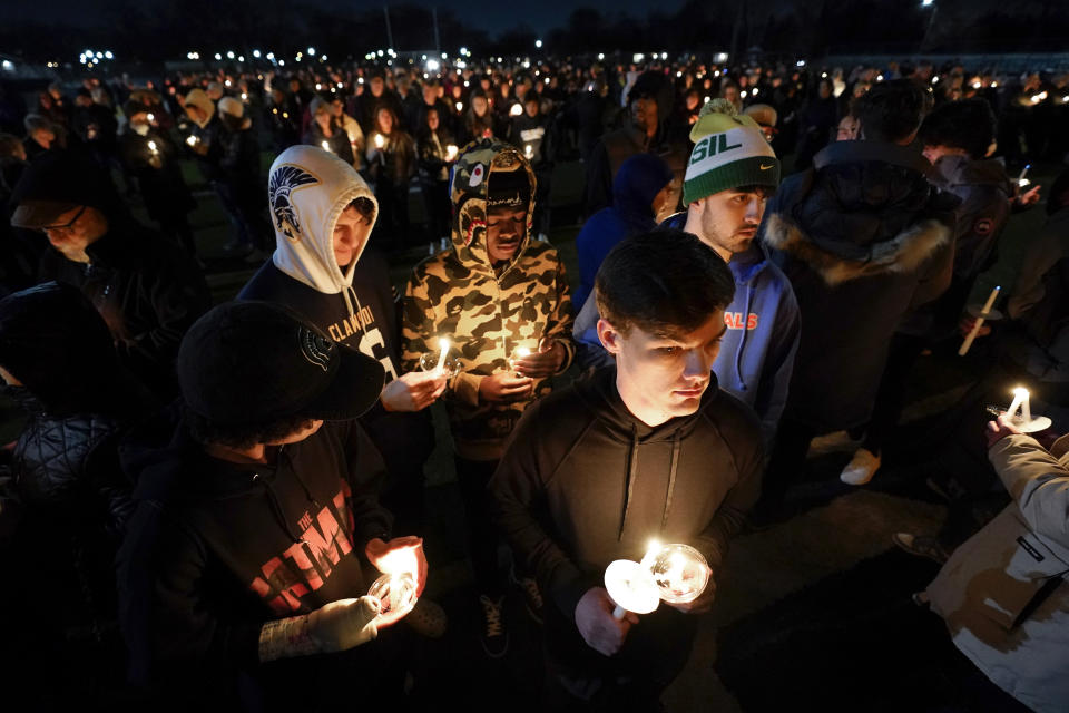 Mourners attend a candlelight vigil for Alexandria Verner at the Clawson High School football field in Clawson, Mich., Tuesday, Feb. 14, 2023. Verner was among the students killed after a gunman opened fire on the campus of Michigan State University Monday night. (AP Photo/Paul Sancya)