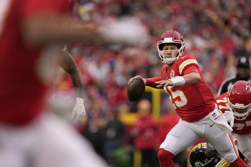 Kansas City Chiefs quarterback Patrick Mahomes prepares to throw as he scrambles.