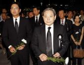 FILE PHOTO: Lee, former Samsung Group chairman, and his son Lee Jae-yong wait to make a call of condolence for the late President Kim at a memorial altar at the National Assembly in Seoul