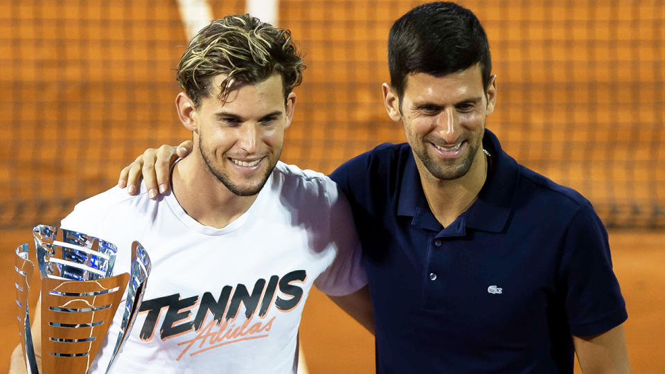 Dominic Thiem (pictured left) and Novak Djokovic (pictured right) embracing and posing for photos.