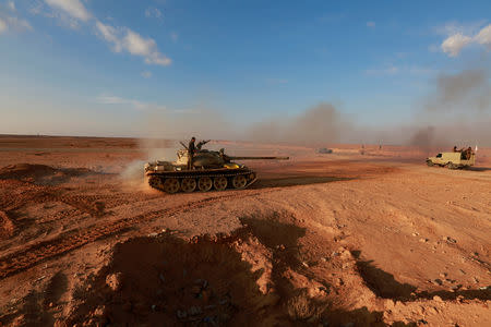 Popular Mobilisation Forces (PMF) fighters ride in a tank near Iraq's border with Syria border in al-Qaim, Iraq, November 26, 2018. REUTERS/Alaa al-Marjani