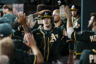 Oakland Athletics' Sean Murphy (12) is congratulated by teammates after hitting a solo home run during the seventh inning of a baseball game against the Texas Rangers, Wednesday, June 23, 2021, in Arlington, Texas. (AP Photo/Brandon Wade)