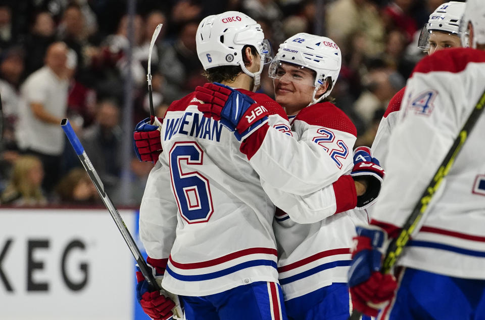 Montreal Canadiens' Chris Wideman (6) hugs Cole Caufield's (22) after he scored their first goal against the Arizona Coyotes in the second period during an NHL hockey game, Monday, Dec. 19, 2022, in Tempe, Ariz. (AP Photo/Darryl Webb)