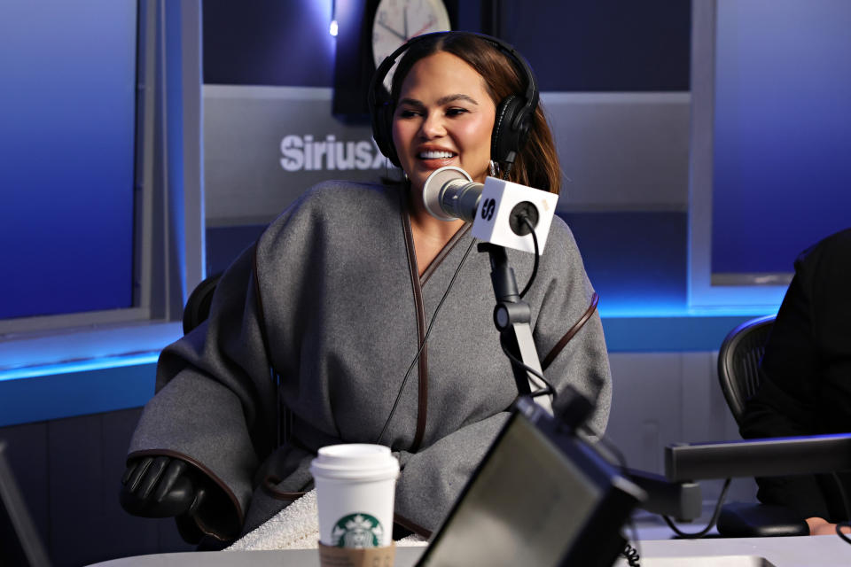 Closeup of Chrissy Teigen speakind during a podcast interview