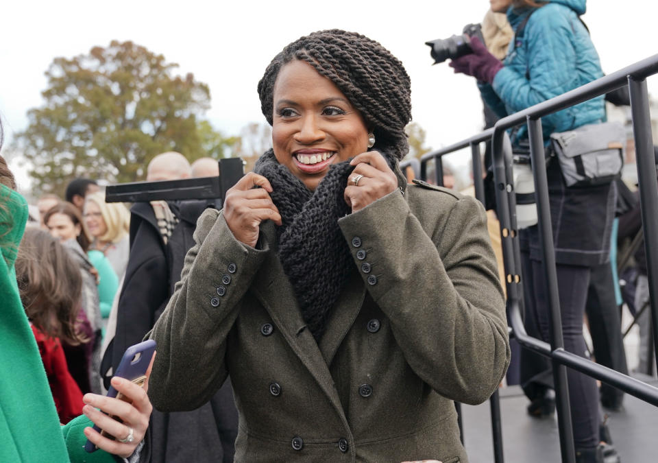 FILE - In this Nov. 14, 2018, file photo, then-Rep.-elect Ayanna Pressley, D-Mass., adjusts her coat after posing with other members of the freshman class of Congress for a group photo opportunity on Capitol Hill in Washington. It's known as "the theater committee" for its high profile, high-drama role investigating President Donald Trump's White House. And now, five of the fieriest Democratic freshmen in the House are players on that stage. (AP Photo/Pablo Martinez Monsivais, file)