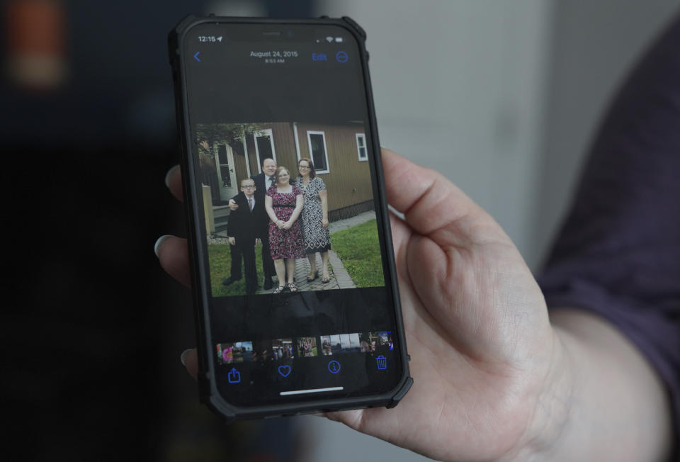 Jennifer Haugh shows a photo of her family from August 2015 before they left the Jehovah's Witnesses faith about a year later in 2016, at her home in York Haven, Pa., on Wednesday, April 12, 2023. (AP Photo/Jessie Wardarski)