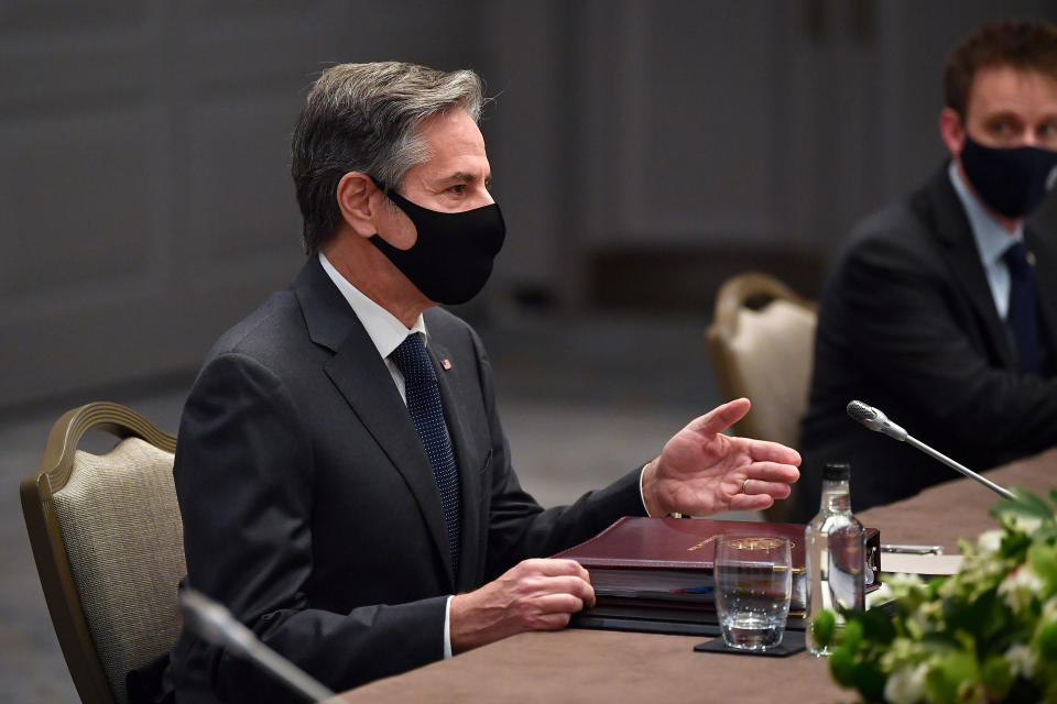 United States Secretary of State Antony Blinken, wearing a face mask to curb the spread of COVID-19, sits at a table for during bilateral talks with Japan's Foreign Minister Toshimitsu Motegi on the sidelines of a G7 foreign ministers meeting, at Grosvenor House Hotel, London, Monday, May 3, 2021. (Ben Stansall/Pool Photo via AP)