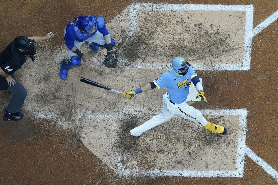 Milwaukee Brewers' Carlos Santana hits a two-run scoring triple during the fifth inning of a baseball game against the Chicago Cubs Friday, Sept. 29, 2023, in Milwaukee. (AP Photo/Morry Gash)