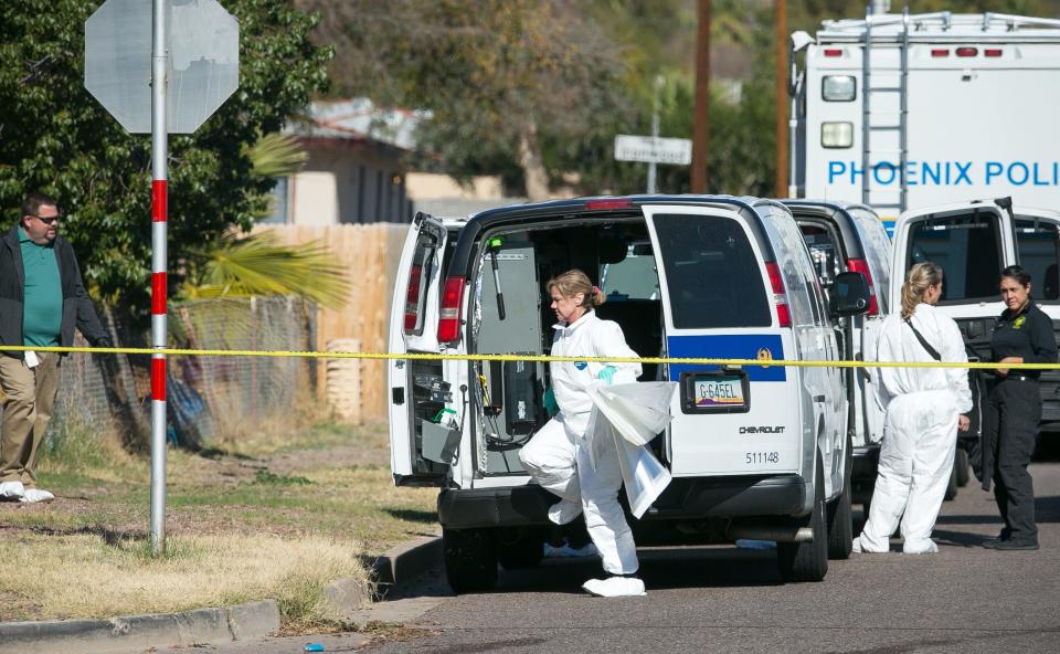 Phoenix investigators on Jan. 14, 2015, look through Bryan Patrick Miller's house.