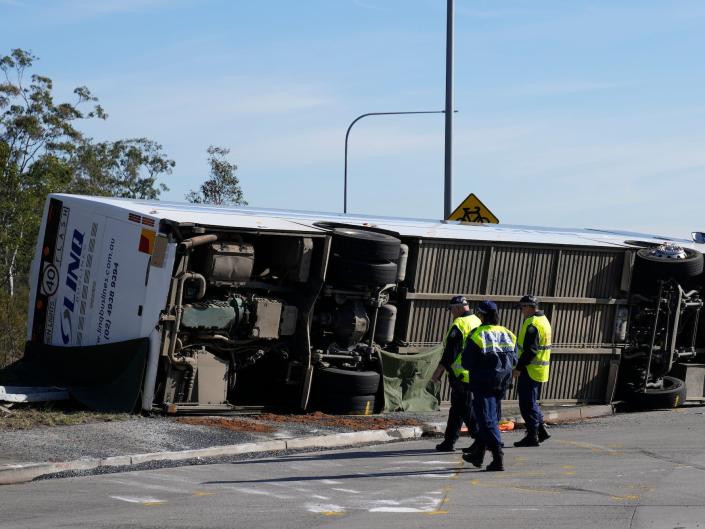 The bus that crashed in Hunter Valley, Australia, sits flipped on its side.