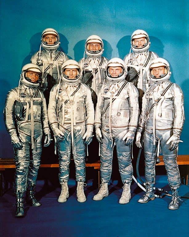 US Mercury program astronauts in their space suits pose for a family picture in 1962