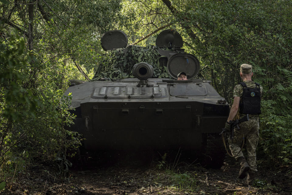 A Ukrainian self-propelled artillery drives to position to shoot towards Russian forces at a frontline in Kharkiv region, Ukraine, Wednesday, July 27, 2022. (AP Photo/Evgeniy Maloletka)