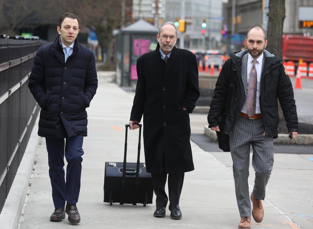 Todd Morgan (l), appearing with his attorneys David and Michael Rothenberg, is Bob Morgan's son.