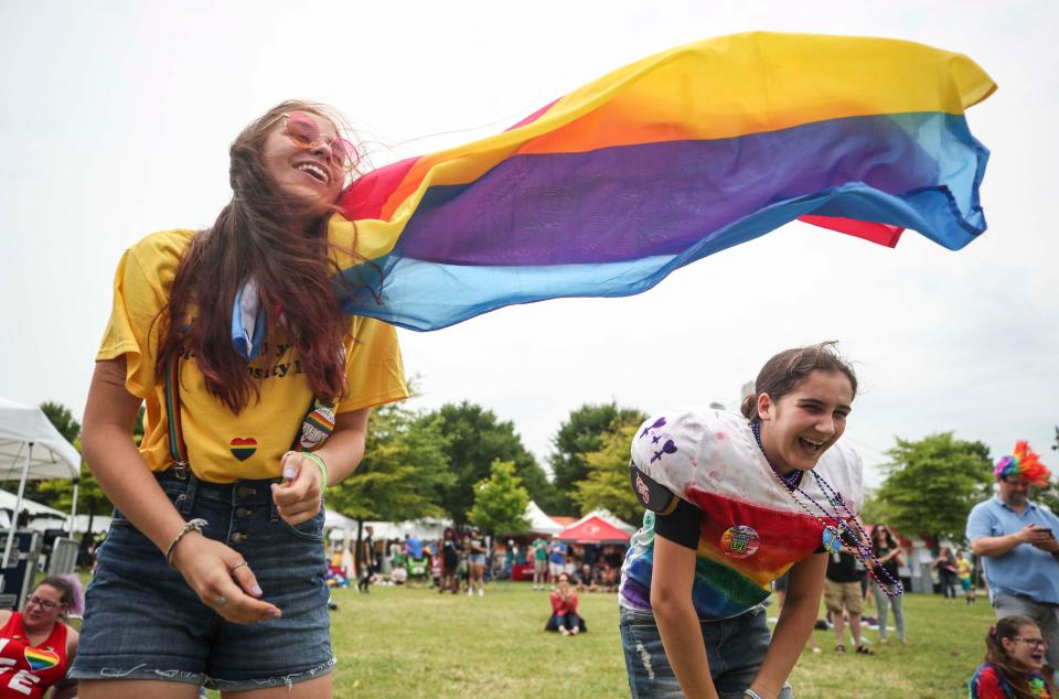 Emily Amaya, right, and Rosemary Peters dance to the music during the 2019 Kentuckiana Pride Festival near the Big Four Bridge Saturday.