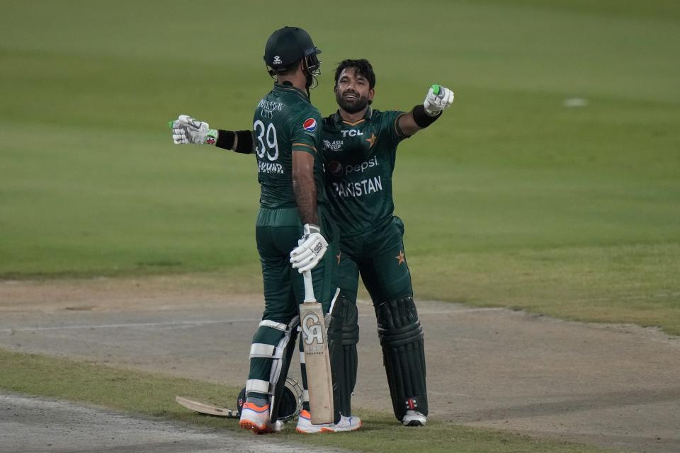 Pakistan's Fakhar Zaman, left, is congratulated by teammate Mohammad Rizwan after scoring fifty during the T20 cricket match of Asia Cup between Pakistan and Hong Kong, in Sharjah, United Arab Emirates, Friday, Sept. 2, 2022. (AP Photo/Anjum Naveed)