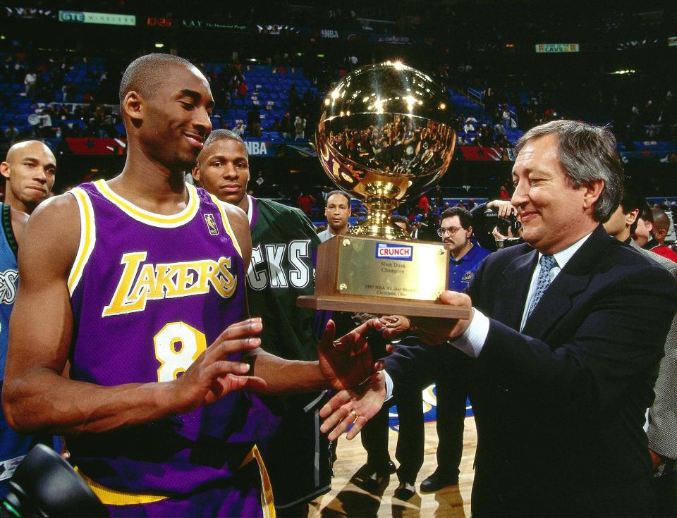 The smiling Laker accepts his trophy for winning the 1997 Nestle Crunch Slam Dunk Contest in Cleveland.