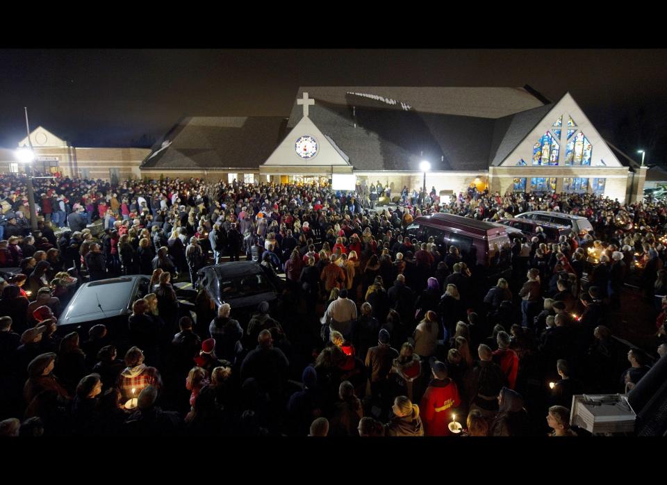 Students and those in the community embrace one another as they hold a candlelight vigil at St Mary's of the Assumption Church in Chardon, Ohio on Feb. 28, 2012. 