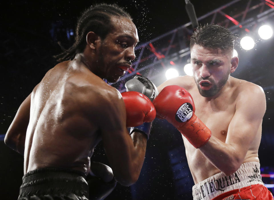 Jose Ramirez (R) punches Amir Imam during the ninth round of a WBC super lightweight championship boxing match Saturday, March 17, 2018, in New York. (AP Photo)