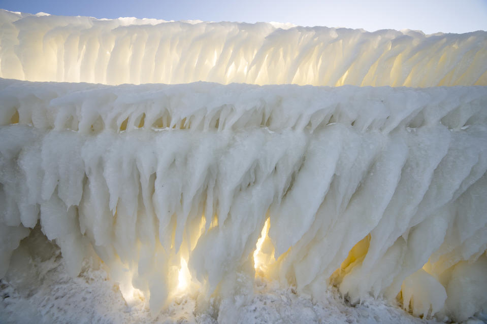 SOUTH HAVEN, MI - JANUARY 13: Thick ice along the pier at Grand Haven Lighthouse, on January 13, 2015, in South Haven, Michigan.ICE engulfs a red lighthouse as a fierce winter storm grips South Haven, Michigan. Sharp icicles and surreal formations can be seen hanging from the railings after strong waves crashed onto the piers. After each coating the water quickly freezes to ice and the pier is transformed into a slippery, white wonderland. Weather in the area dipped into the minus figures and froze over Lake Michigan in the beginning of January.PHOTOGRAPH BY Mike Kline / Barcroft MediaUK Office, London.T +44 845 370 2233W www.barcroftmedia.comUSA Office, New York City.T +1 212 796 2458W www.barcroftusa.comIndian Office, Delhi.T +91 11 4053 2429W www.barcroftindia.com