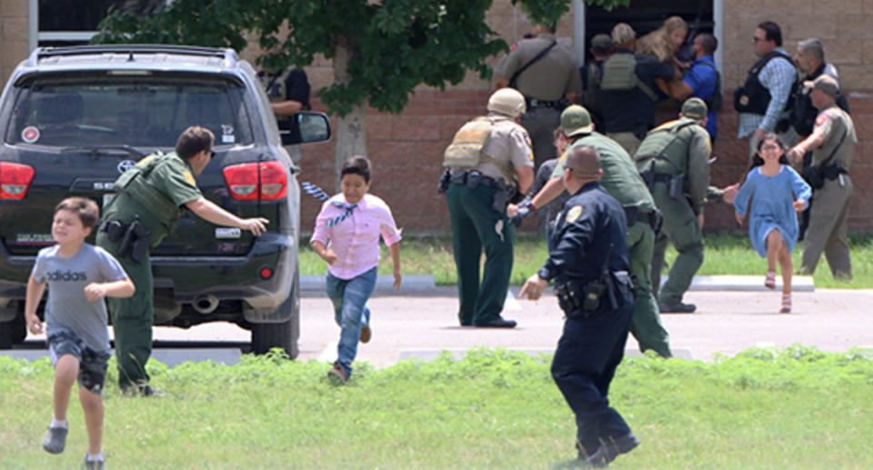 Children run to safety during a mass shooting at Robb Elementary School where a gunman killed nineteen children and two adults in Uvalde, Texas