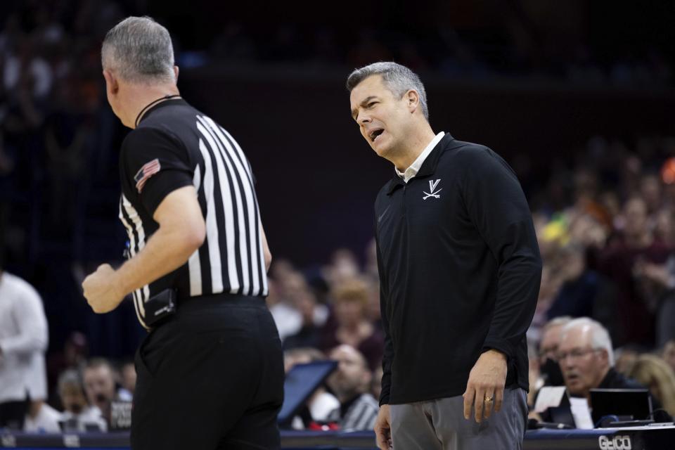 Virginia head coach Tony Bennett disagrees with a referee during the first half of an NCAA college basketball game against Virginia Tech in Charlottesville, Va., Wednesday, Jan. 18, 2023. (AP Photo/Mike Kropf)