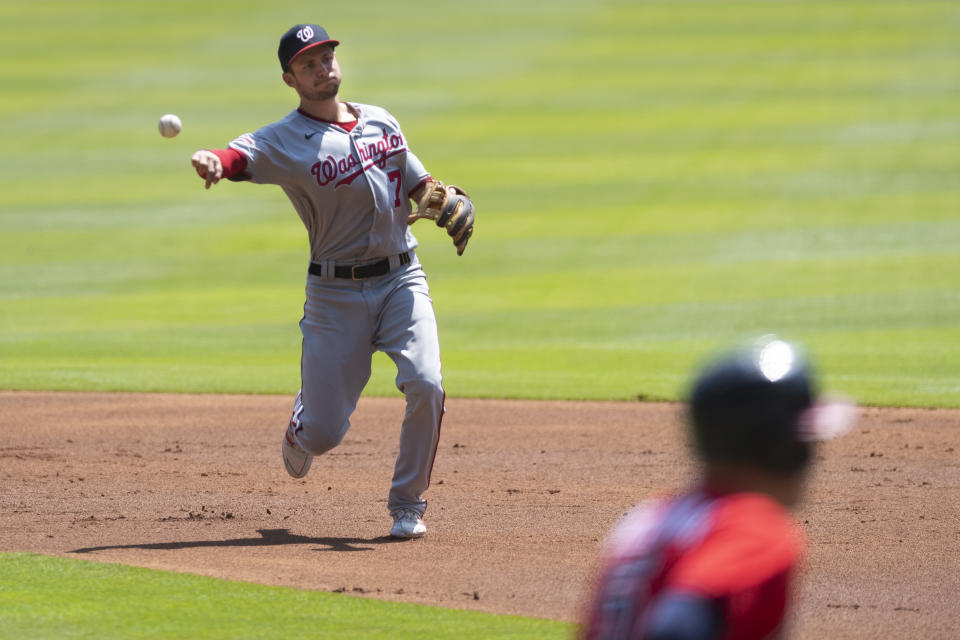 Washington Nationals shortstop Trea Turner (7) throws out Atlanta Braves' Freddie Freeman at first base to turn a double play during the first inning of a baseball game Sunday, Sept. 6, 2020, in Atlanta.(AP Photo/John Amis)