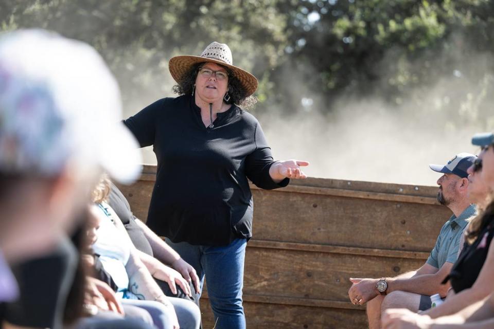 Almond farmer Benina Montes talks with guests during a tour at Burroughs Family Farms east of Denair, Calif., Tuesday, Sept. 19, 2023.