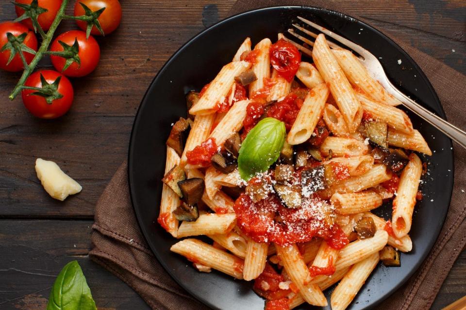 a plate of pasta with a tomato sauce