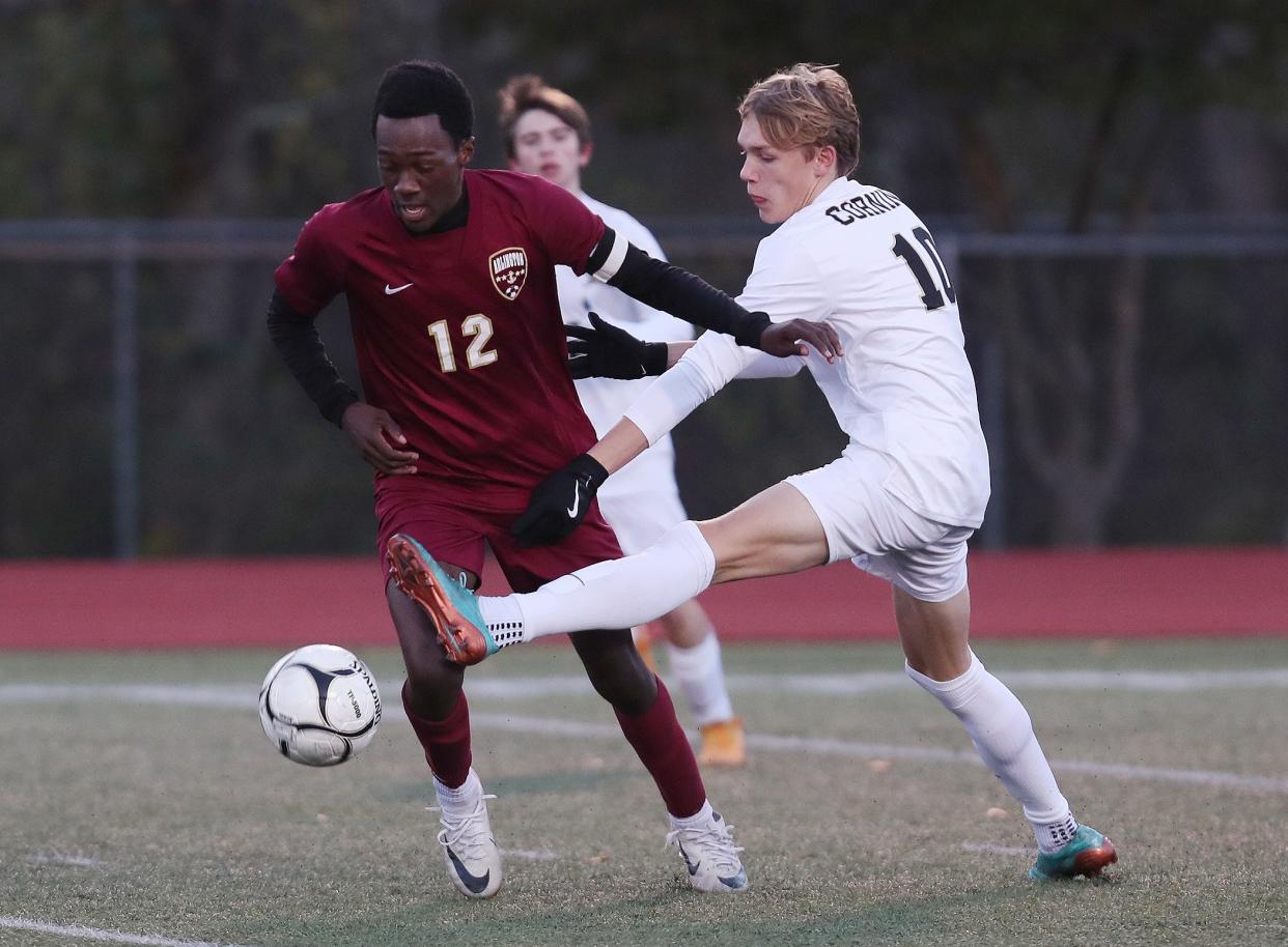 From left, Arlington's Rian Lovell (12) and Corning Painted Post's Jacob Kempton (14) battle for ball control during boys soccer regional playoff at Yorktown High School Nov. 1, 2023. Arlington won the game 3-0.