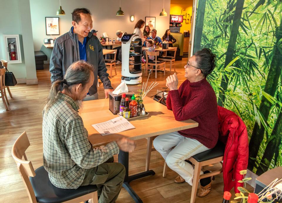 Owner Paul Nguyen chats with customers at his restaurant Eurasian Bistro Saturday, December 17, 2022.