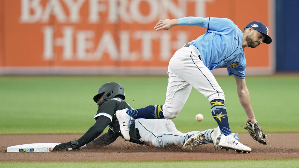 Chicago White Sox's Luis Robert Jr. steals second base as Tampa Bay Rays' Brandon Lowe, right, can't field the throw during the first inning of a baseball game Sunday, April 23, 2023, in St. Petersburg, Fla. (AP Photo/Chris O'Meara)