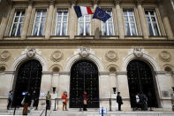 Local residents queue to get protective mask at the Neuilly-sur-Seine town hall, outside Paris, Tuesday, May 12, 2020. France is cautiously easing the two-month lockdown across the country. Specific measures, such as more widely spaced stalls, have been implemented to enforce physical distancing.(AP Photo/Christophe Ena)